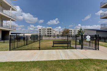 A black gate blocks the entrance to a parking lot.