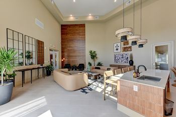A modern kitchen with a wooden island and a dining table with chairs.