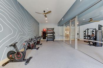 A room with exercise equipment and a wall with a wavy pattern.