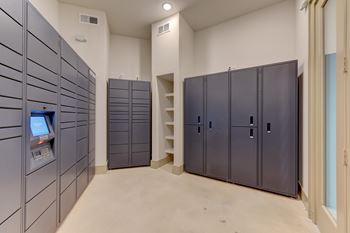 A room with grey lockers and a white wall.