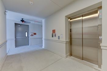 A room with a ceiling fan and a glass door.