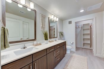 A bathroom with a sink, mirror, and towel rack.