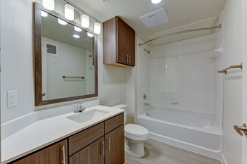A white sink with a brown mirror above it.