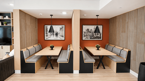 A modern dining room with a long table and chairs.