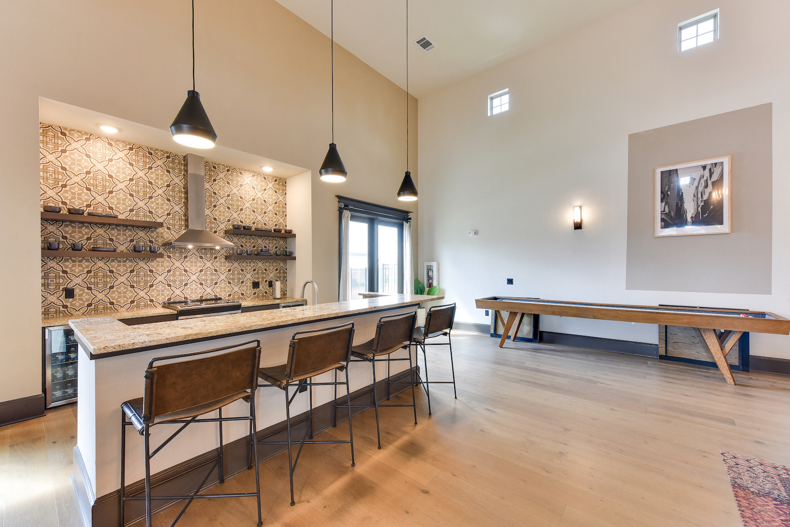 a large kitchen with a long bar and a pool table