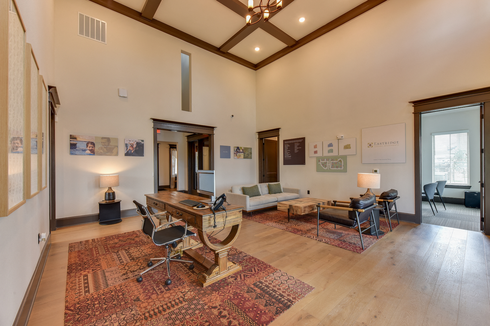 a living room with a desk and a couch and a table