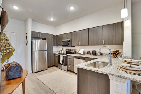 a kitchen with stainless steel appliances and granite counter tops