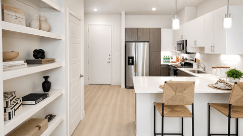 A kitchen with a white counter and a refrigerator.