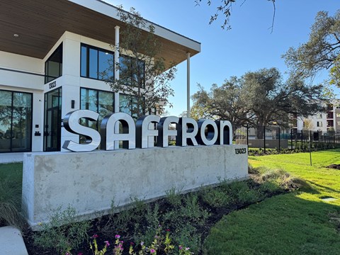 Property entrance sign with landscaping at Bridge at Saffron Apartments, Austin, 78717