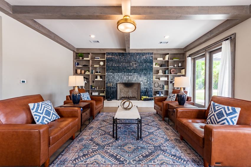 a living room with leather couches and a fireplace a living room with leather couches and a fireplace - Photo Gallery