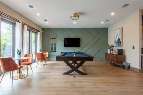 a game room with a pool table and a flat screen tv at Bridge at Paloma Apartments, Austin, TX, 78754