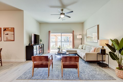 A living room with a brown leather chair and a blue rug.
