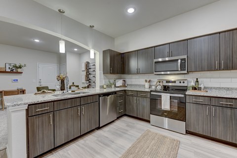 a kitchen with stainless steel appliances and wooden cabinets