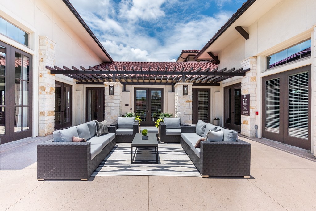 a patio with couches and a coffee table under a pergola at Avery Ranch, Texas