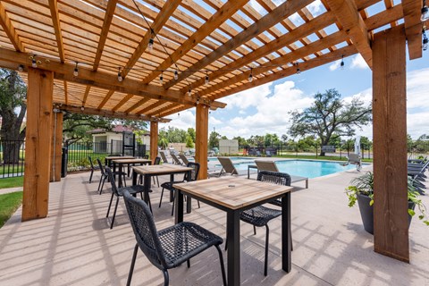 the reserve at bucklin hill leasing office patio with pergola and pool at Avery Ranch, Austin