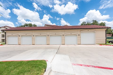 a building with three garages and a blue sky with white clouds at Avery Ranch, Texas, 78717