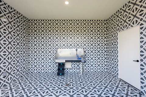 a small room with a white sink and black and white tiles on the floor and walls at Avery Ranch, Austin, 78717