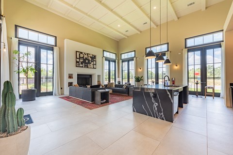 a large open living room with a fireplace and a large kitchen with a large island at Avery Ranch, Austin, 78717