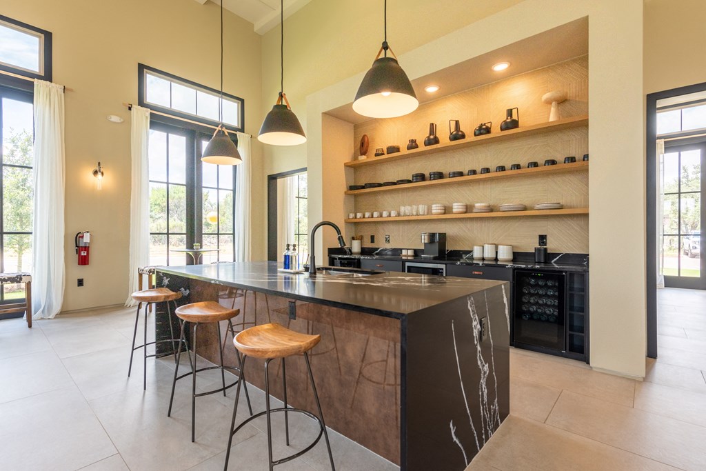 a kitchen with an island and stools at Avery Ranch, Austin, Texas