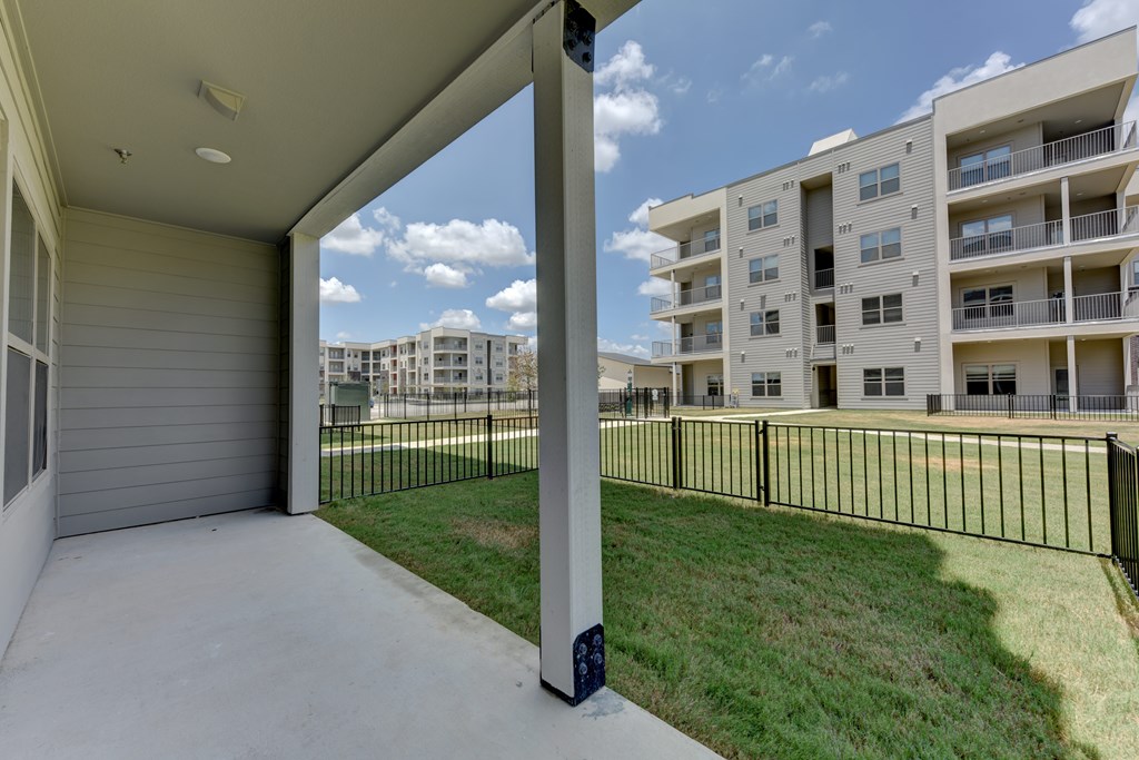 A view of a balcony with a building in the background.