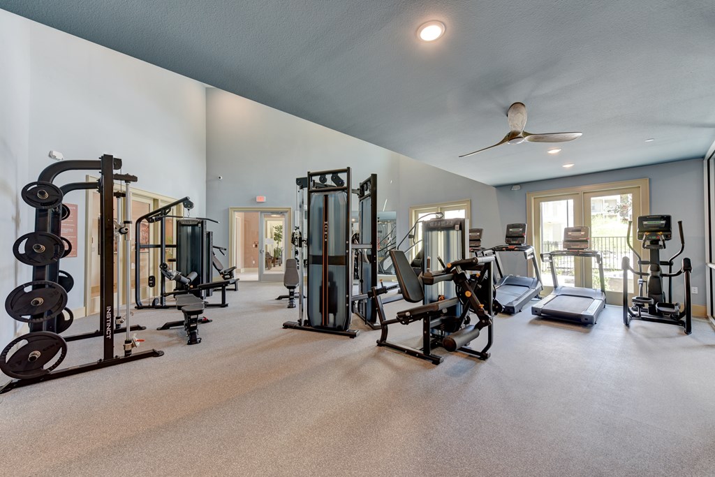 A spacious home gym with a variety of equipment.