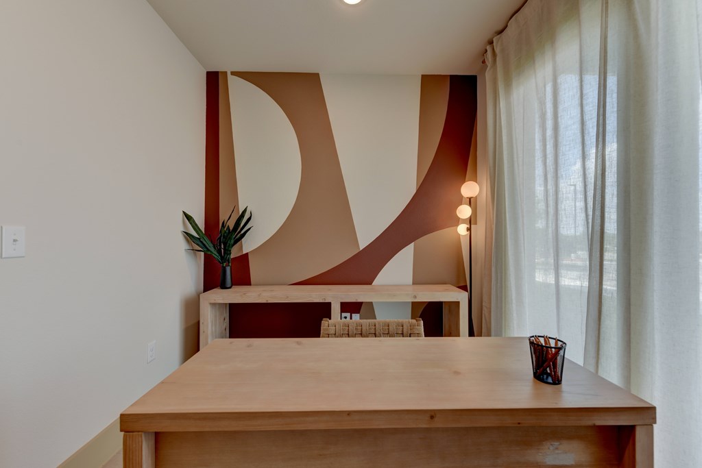 A dining table with a vase of flowers on it.