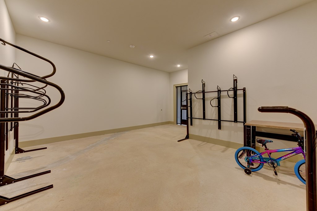 A room with a spiral staircase and a bicycle.