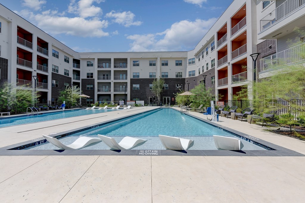 A swimming pool in a residential complex with a "NO DIVING" sign.