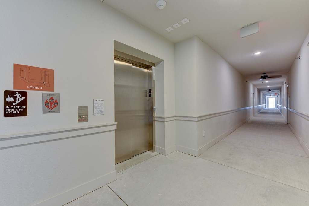 A hallway with a sign that says Level 4 on the wall.