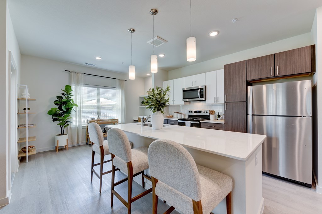 A modern kitchen with a dining table and chairs.