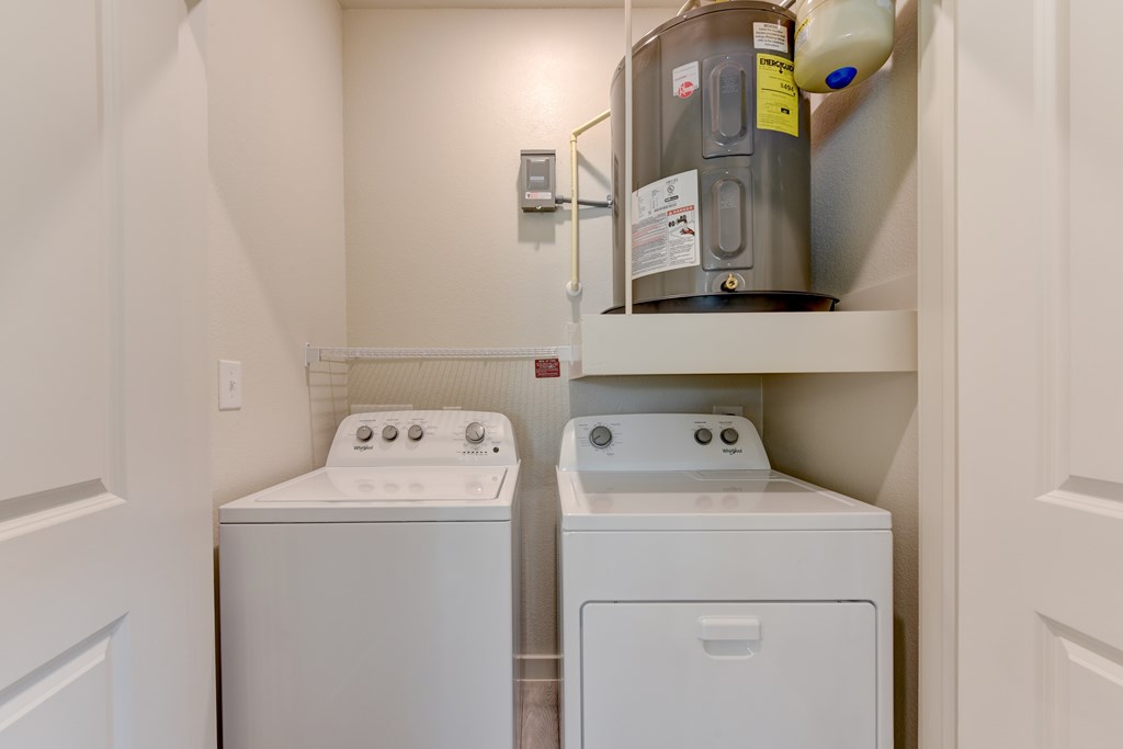 A small laundry room with a washer and dryer.
