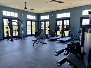a gym with exercise equipment and windows at Three Hills, Texas