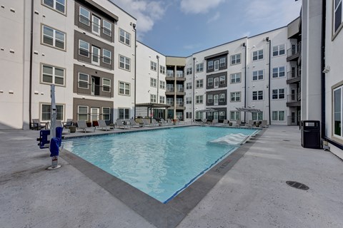Courtyard pool surrounded by modern apartment buildings at Matador Apartments, Austin, TX 78745