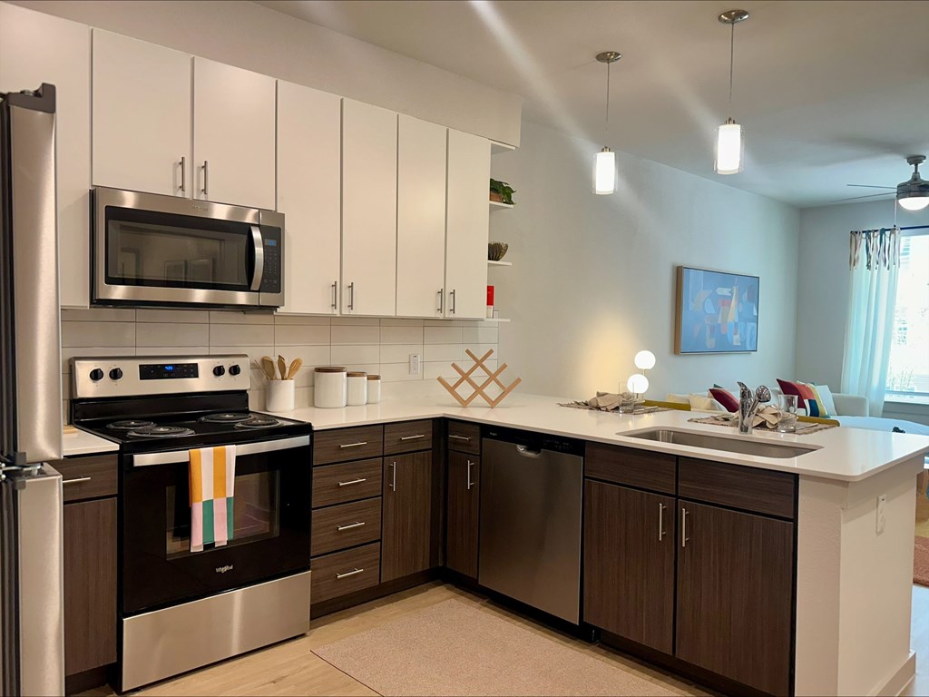 A kitchen with white cabinets and a black stove top oven.