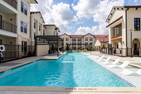 A swimming pool in a residential area with a depth marker indicating 4 feet 6 inches.