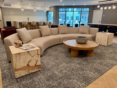 A living room with a large sectional sofa and a coffee table.