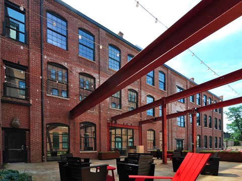 A red brick building with a red ramp in front.