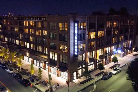 A building with the name "BEMINGTON ROV" is lit up at night.