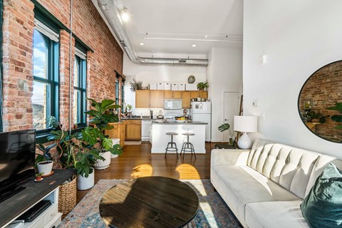 A living room with a white couch and a wooden coffee table.