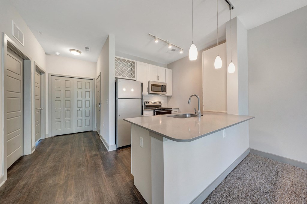 a renovated kitchen with white cabinets and a large counter top  at Avellan Springs Apartments, North Carolina