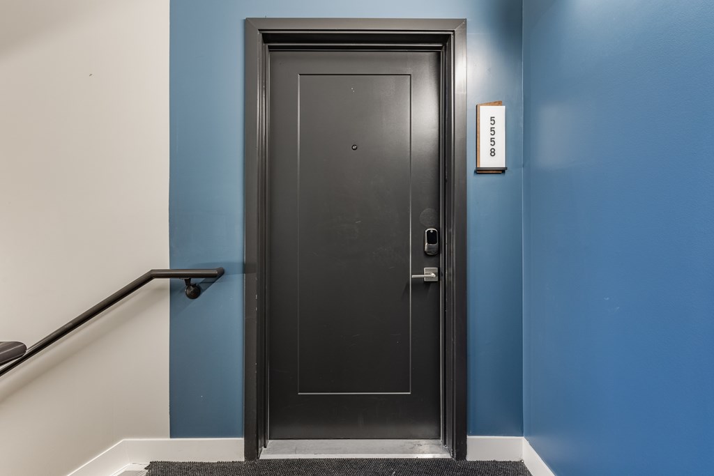 A black door with a handle and a doorknob with a wall on the side at Upper Vue Flats, Dublin