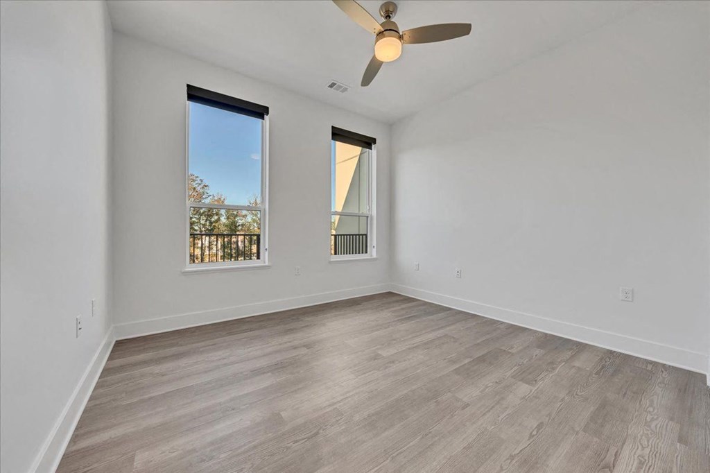 an empty living room with a ceiling fan and a window at Luxe 360 in Midlothian, Virginia