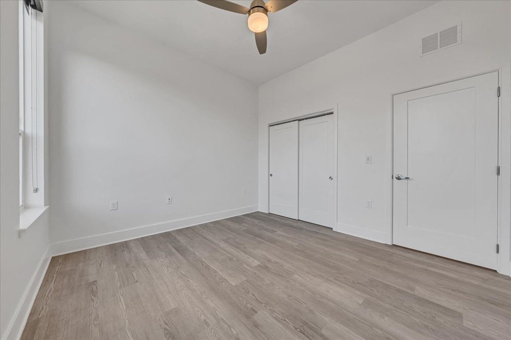 an empty living room with white walls and wood floors at Luxe 360 in Midlothian, Midlothian, VA 23114