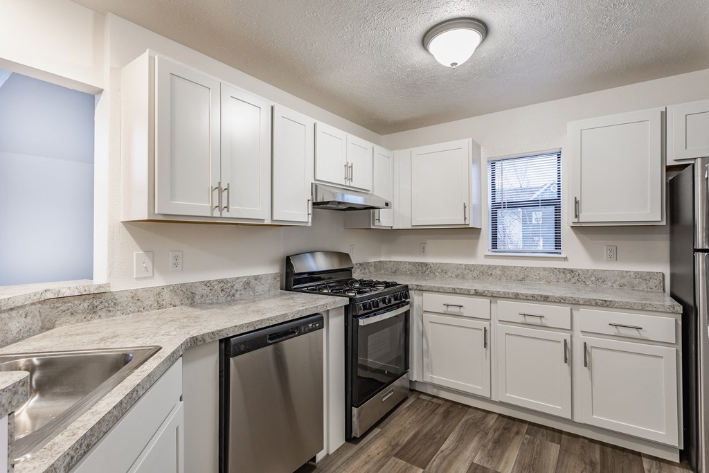 A kitchen with white cabinets and stainless steel appliances at Huntington Cove Apartments, Merrillville, IN, 46410