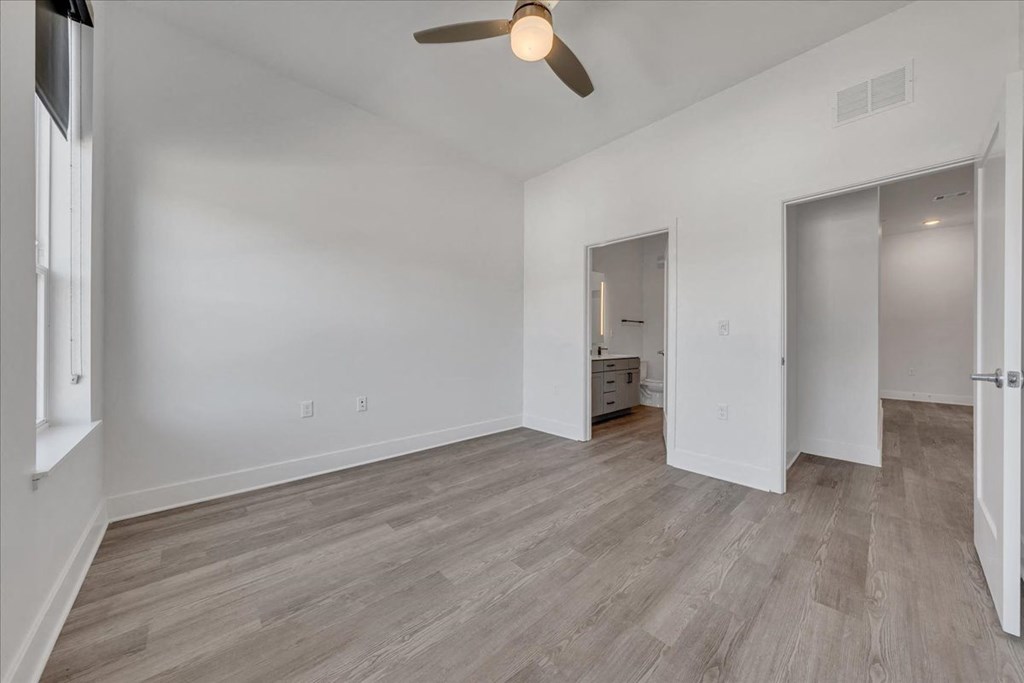 a living room with white walls and a ceiling fan at Luxe 360 in Midlothian, Midlothian, VA