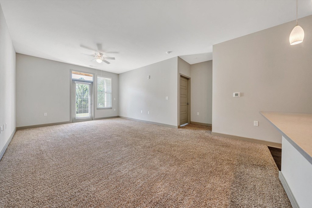 an empty living room with white walls and a ceiling fan  at Avellan Springs Apartments, North Carolina, 27560