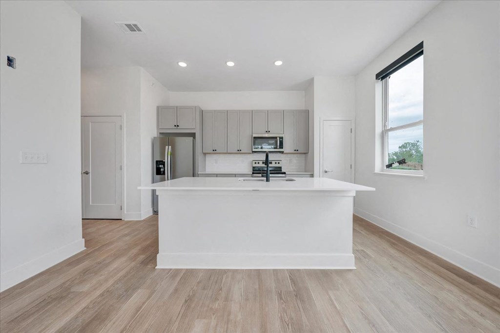 a kitchen with a large center island  at Luxe 360 on Centerpointe Apartments, Midlothian