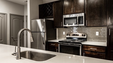 a kitchen with stainless steel appliances and a sink