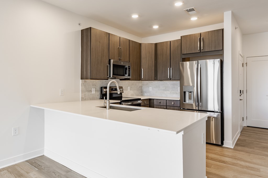 A modern kitchen with a white countertop and stainless steel appliances at Upper Vue Flats, Dublin