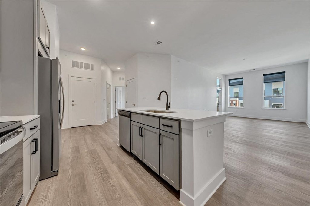 an open kitchen and living room with a refrigerator and a sink at Luxe 360 in Midlothian, Midlothian